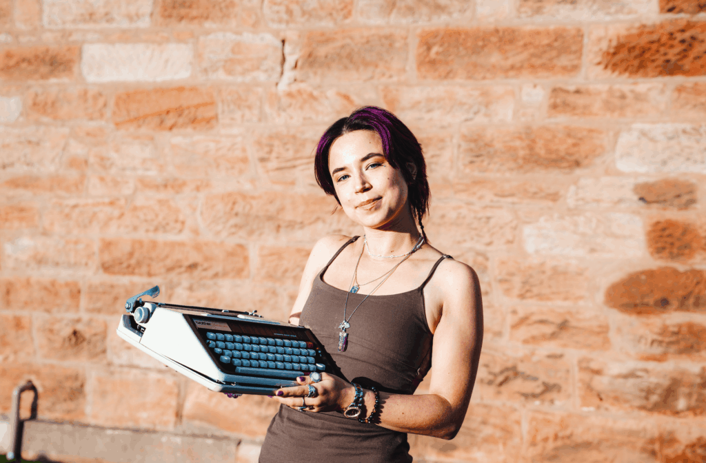 Heather Rose holding a typewriter
