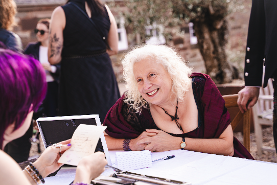 client reacting happily to custom poem being read aloud